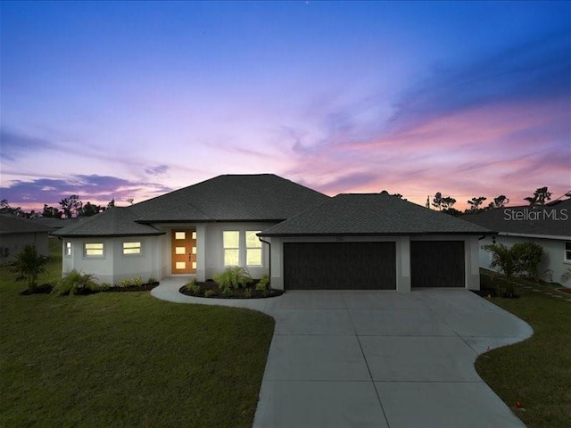 view of front of property featuring a garage, concrete driveway, french doors, a front yard, and stucco siding