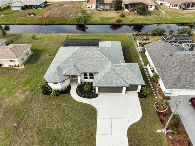 drone / aerial view with a residential view and a water view