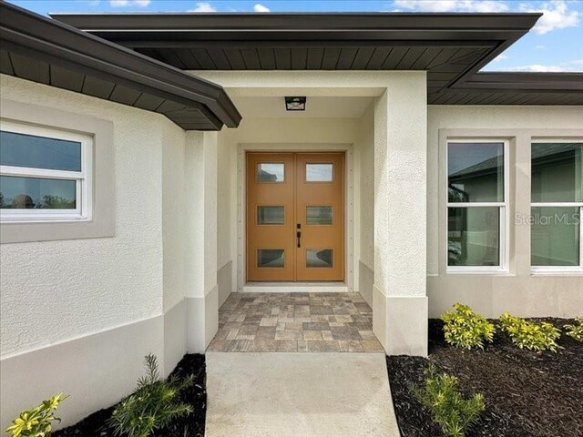 doorway to property with french doors and stucco siding