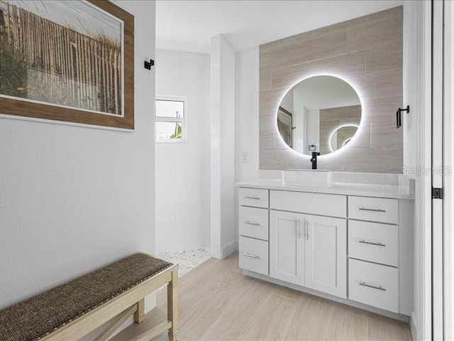 full bathroom featuring walk in shower, wood finished floors, and vanity