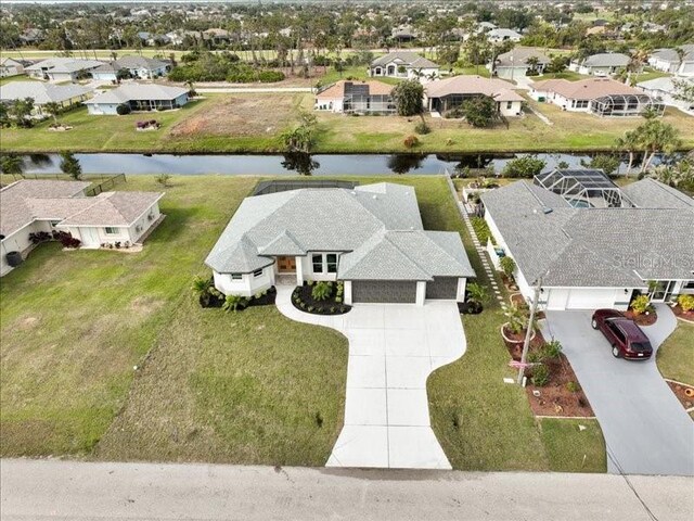 drone / aerial view featuring a residential view and a water view