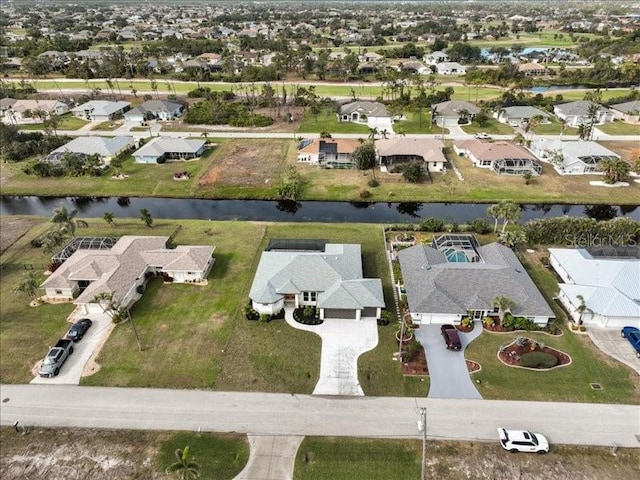 drone / aerial view with a water view and a residential view