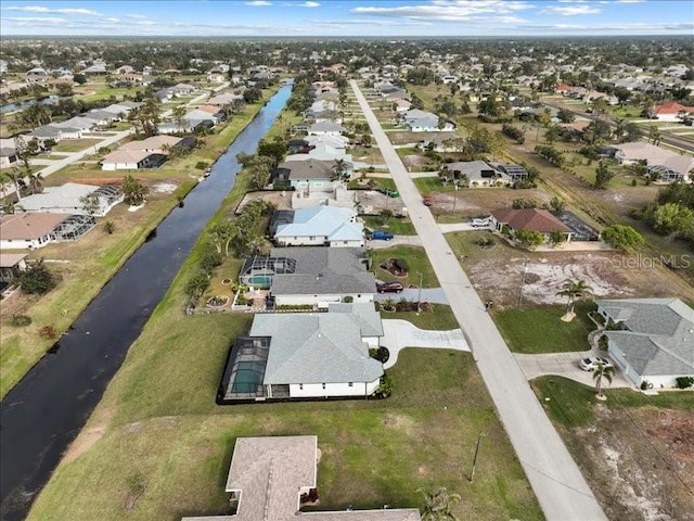 drone / aerial view featuring a water view and a residential view