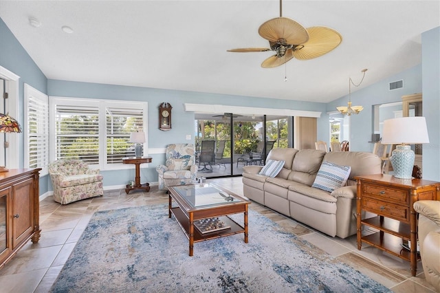 tiled living room featuring ceiling fan with notable chandelier and vaulted ceiling