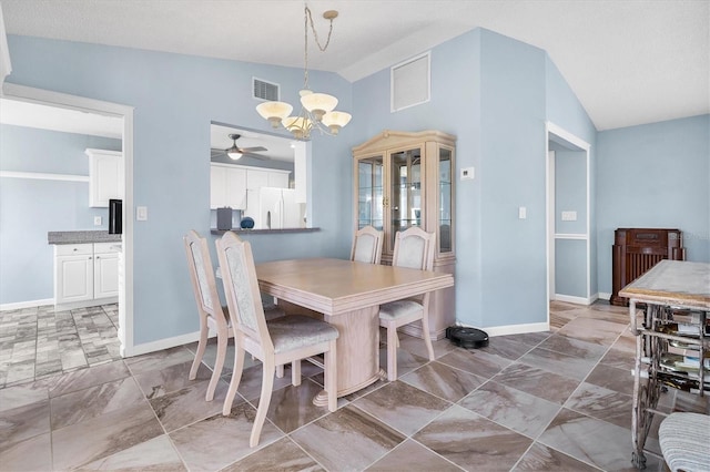 dining room with lofted ceiling and ceiling fan with notable chandelier