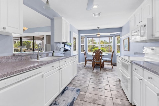 kitchen with white cabinetry, sink, white appliances, and hanging light fixtures