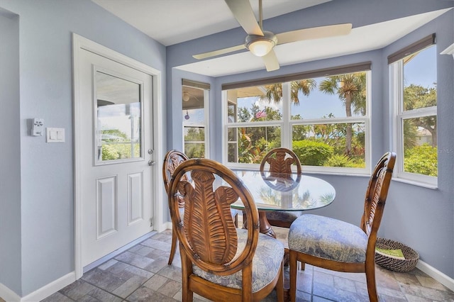 sunroom featuring ceiling fan