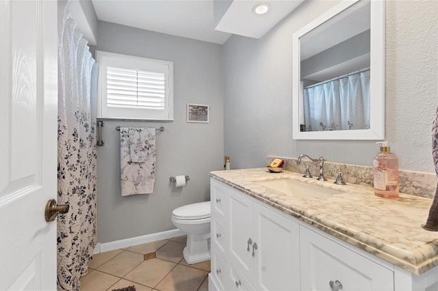 bathroom featuring vanity, toilet, and tile patterned flooring