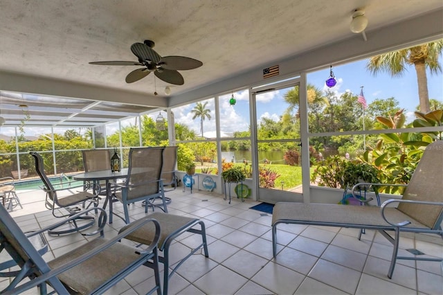 unfurnished sunroom featuring ceiling fan