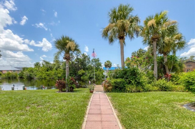 view of community featuring a water view and a lawn