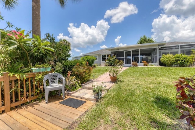 view of yard with a deck and a sunroom