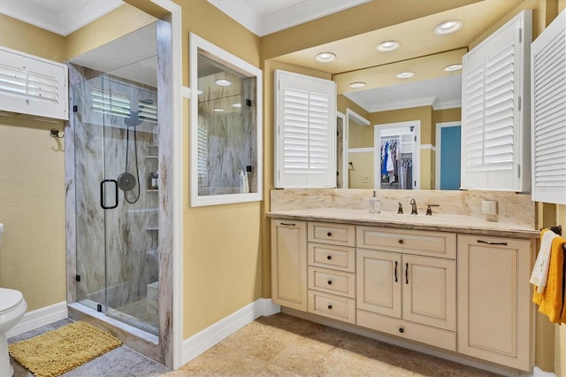 full bath with toilet, crown molding, baseboards, a shower stall, and vanity