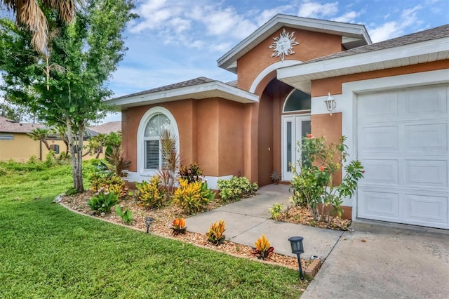 ranch-style home with a garage and a front lawn