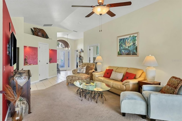 tiled living room featuring ceiling fan and vaulted ceiling