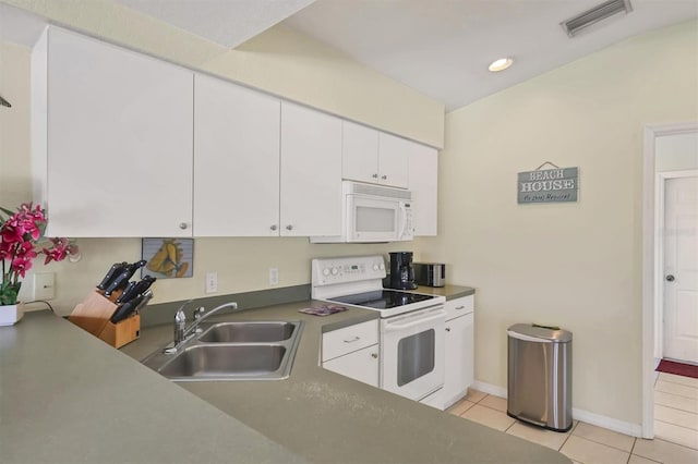 kitchen with sink, light tile patterned floors, white cabinets, and white appliances