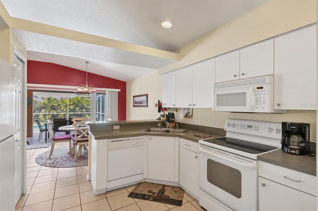 kitchen with white cabinetry, white appliances, lofted ceiling, and kitchen peninsula