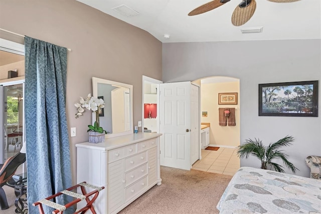 carpeted bedroom featuring vaulted ceiling, connected bathroom, and ceiling fan