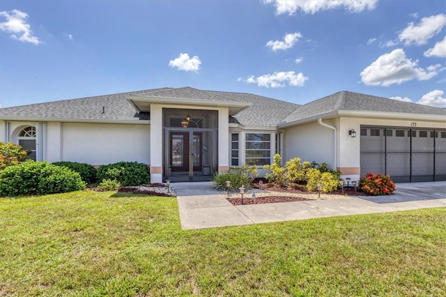 view of front of property with a garage and a front yard