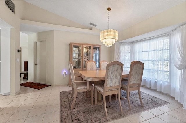 dining room featuring a chandelier, vaulted ceiling, and light tile patterned floors