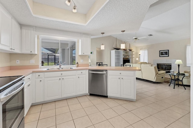 kitchen featuring stainless steel appliances, sink, white cabinets, and kitchen peninsula