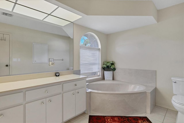 bathroom with tile patterned flooring, vanity, a tub to relax in, and toilet