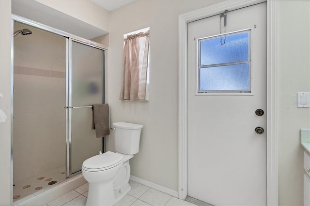 bathroom featuring tile patterned flooring, toilet, vanity, and a shower with shower door