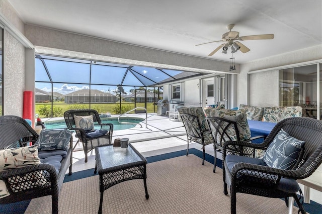 view of patio featuring a lanai, outdoor lounge area, and ceiling fan