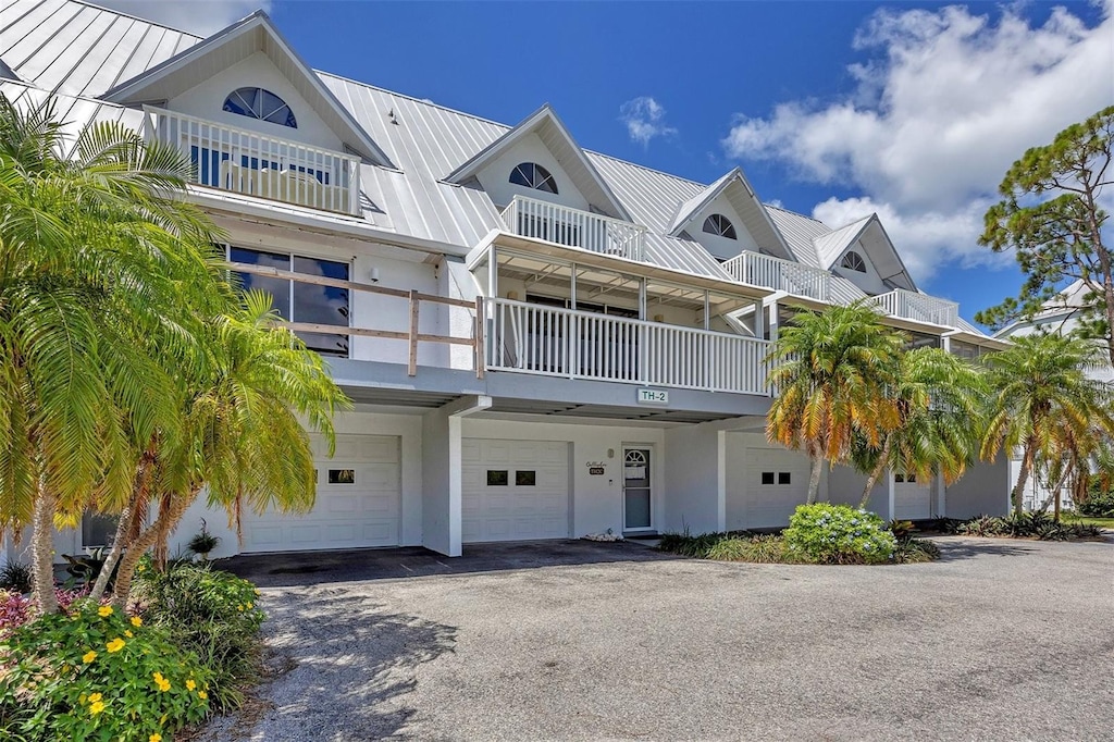 view of front facade featuring a garage and a balcony