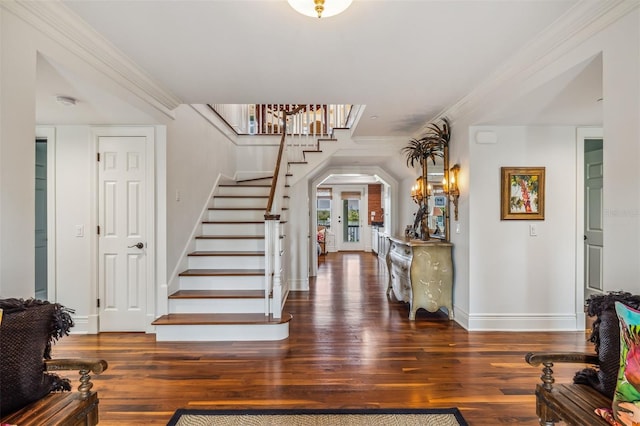 entryway with crown molding, dark wood-type flooring, and french doors