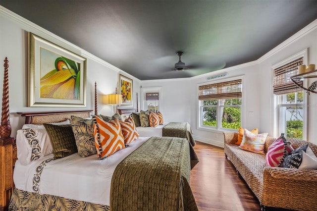 bedroom with crown molding, wood-type flooring, and ceiling fan