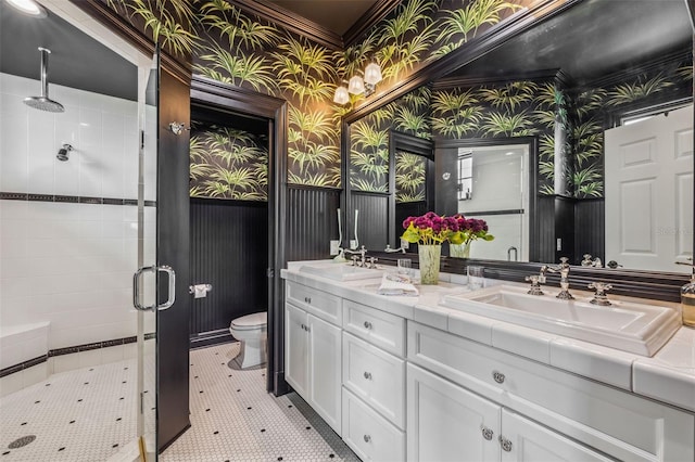 bathroom featuring toilet, vanity, tile patterned floors, and a shower with shower door