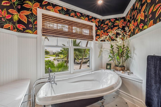 bathroom with crown molding and a bathing tub