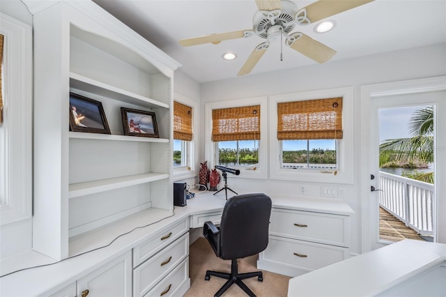 office space featuring built in desk and ceiling fan