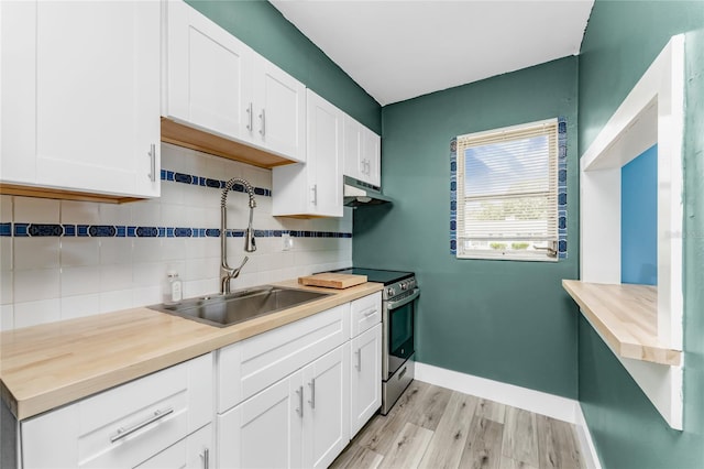 kitchen with backsplash, stainless steel electric stove, sink, light wood-type flooring, and white cabinetry