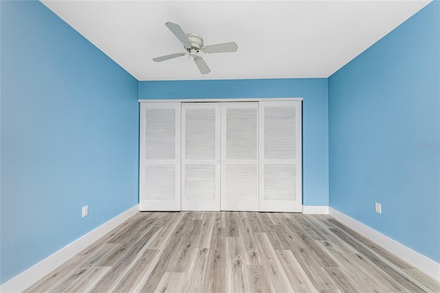 unfurnished bedroom featuring light hardwood / wood-style floors, a closet, and ceiling fan