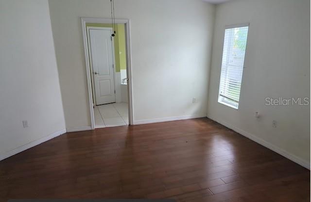 unfurnished room featuring wood-type flooring