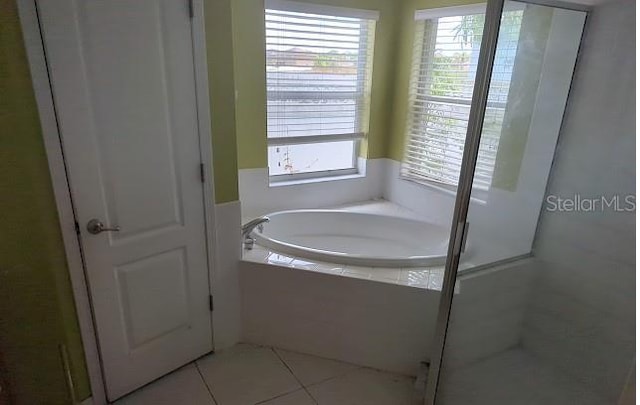 bathroom featuring separate shower and tub and tile patterned floors