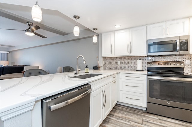 kitchen with ceiling fan, tasteful backsplash, stainless steel appliances, pendant lighting, and sink