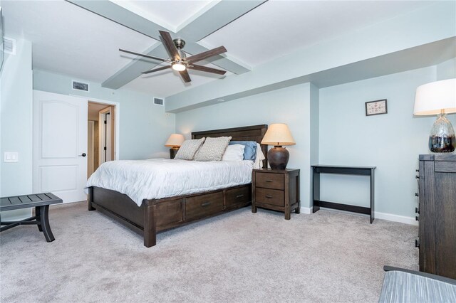 carpeted bedroom featuring beamed ceiling and ceiling fan