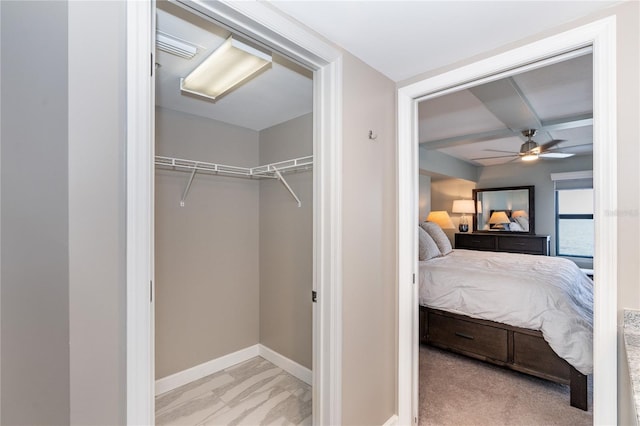 interior space with light colored carpet, a closet, and ceiling fan