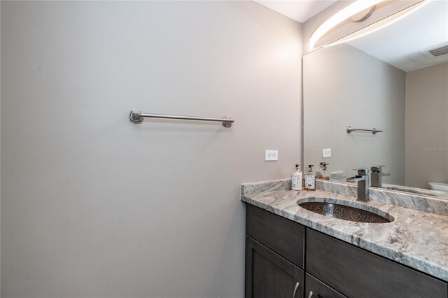 bathroom with toilet and vanity