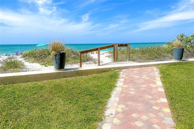 view of property's community with a yard and a water view