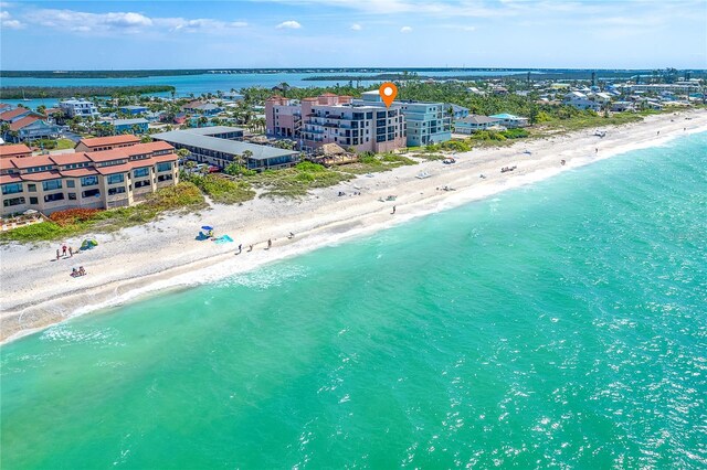 birds eye view of property with a beach view and a water view