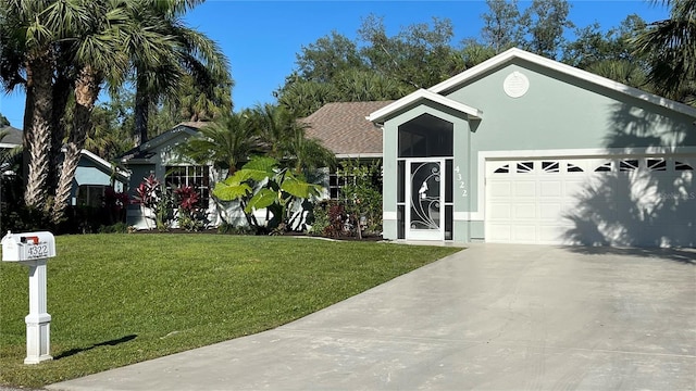 single story home featuring a garage and a front lawn