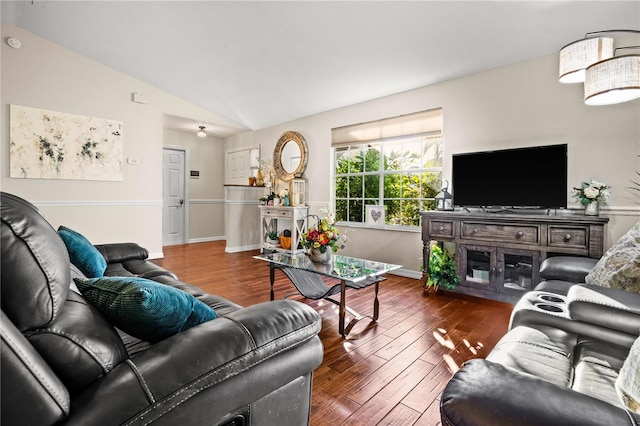 living room featuring lofted ceiling and dark hardwood / wood-style floors