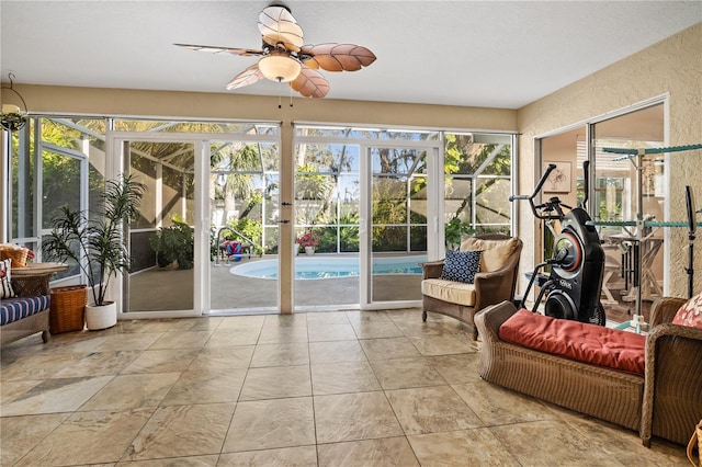 sunroom featuring a healthy amount of sunlight and ceiling fan