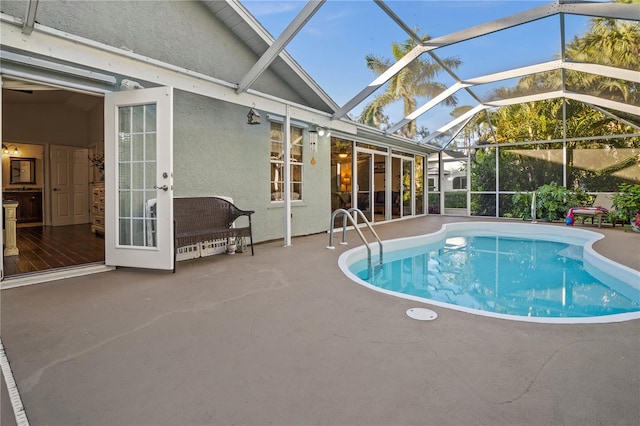 view of pool featuring a patio and glass enclosure