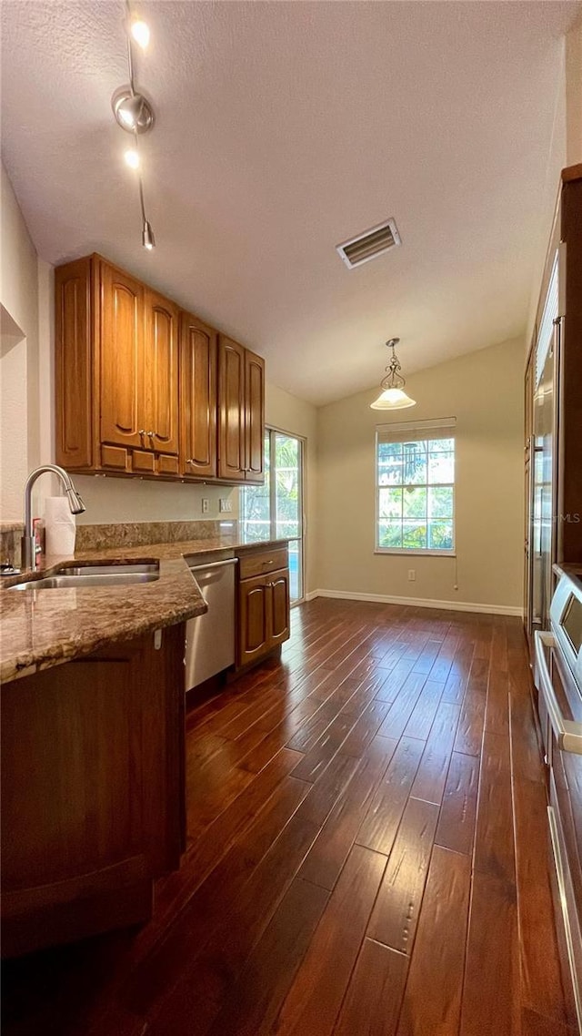 kitchen with pendant lighting, dishwasher, a textured ceiling, dark hardwood / wood-style floors, and sink