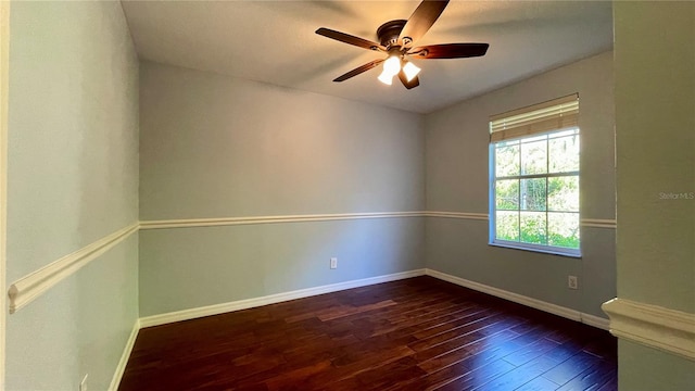 spare room featuring ceiling fan and dark wood-type flooring