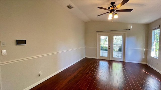 empty room with ceiling fan, lofted ceiling, french doors, and dark hardwood / wood-style flooring